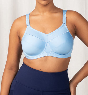Woman wearing light blue sport bra with navy tights